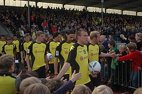 Borussia Dortmund Squad (before a football match and greeted by BVB fans).jpg