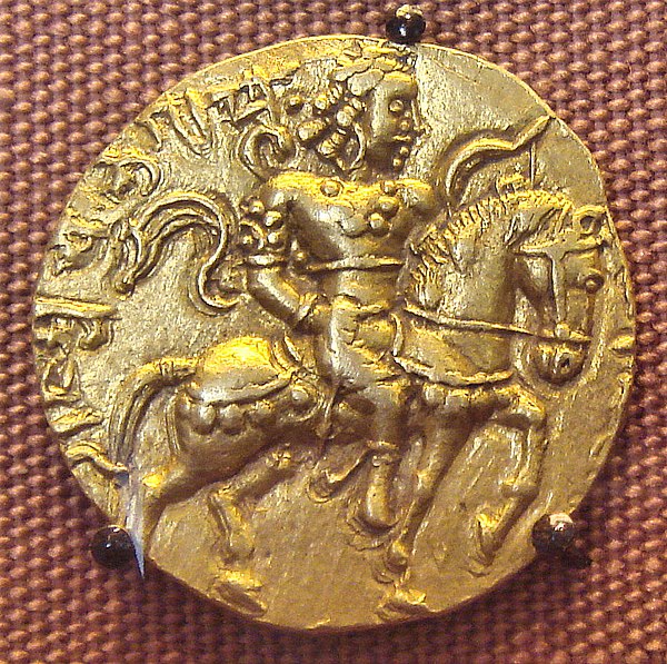 An 8 gram gold coin featuring Chandragupta II astride a caparisoned horse with a bow in his left hand. The name Cha-gu-pta appears in the upper left q