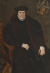 Portrait of a large man, seated, holding a book