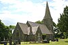 A stone church with tower and spire