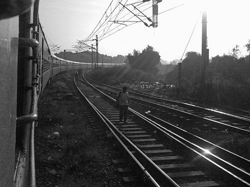 An endless train, a man going to work, just outside Mumbai