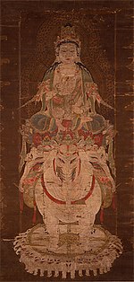 Frontal view of a deity seated on a three-headed white elephant.