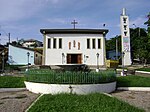 Uma praça com uma fonte e ao fundo a fachada de uma igreja