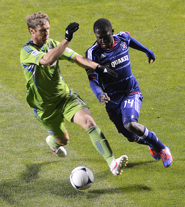 Chicago's Patrick Nyarko (right) dribbling past a Seattle defender during an April 2012 match