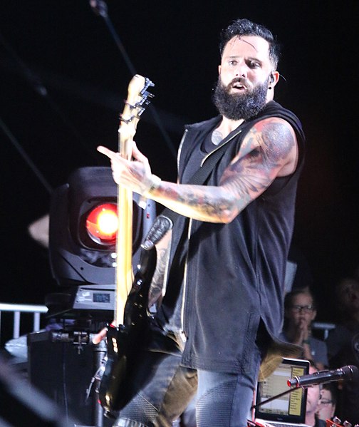 Cooper playing bass guitar in 2017