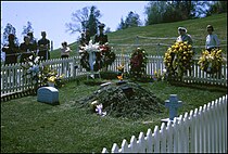 The original John F. Kennedy gravesite and Eternal Flame as they looked in May, 1964, 20 feet up the hill from the present-day relocated memorial. John F Kennedy grave at Arlington with Eternal Flame, May 1964.jpg