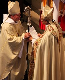 Doug Sparks, 8th bishop, receiving the crozier from his predecessor, Edward S. Little II LittleSparksCrozier.jpg