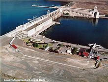 Lower Monumental Dam with the lock in the center of the river (far side in photo), the power generation on the northwest side of the river, and spillway in the middle of the dam, between the powerhouse and the lock.