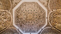 The muqarnas dome inside the mihrab; the sides are also covered in carved stucco with arabesque and pine cone motifs
