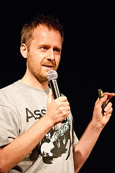 Man in a T-shirt giving a talk