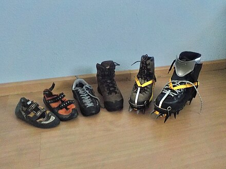 From left to right: two rock climbing shoes, approach shoe, hiking boot, a leather mountaineering boot and a plastic mountaineering boot. The mountaineering boots are fitted with automatic crampons