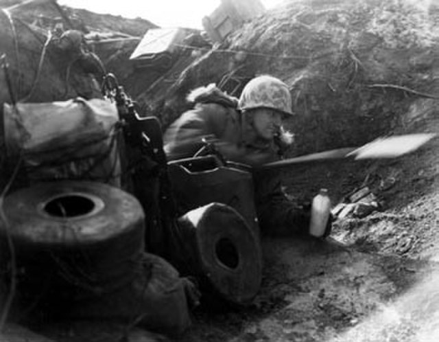 A U.S. Marine in a trench atop Outpost Vegas.