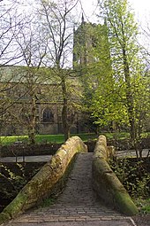 Mellor Bridge, one of Marsden's two packhorse bridges, with St Bartholomew's Church in the background