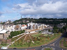 The Scottish Parliament Building with Calton Hill in the background Parliament building (24400311378).jpg