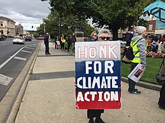 Protester holding Honk for Climate Action sign on Sturt Street median — May 2022.jpg