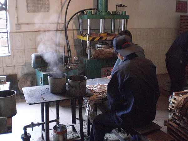 A pu'er tea factory, which steams, bags, and presses the loose leaf pu'er into tea bricks