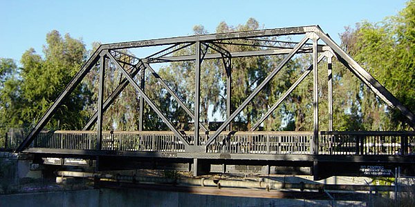 A truss bridge operated by Southern Pacific Railroad in Contra Costa County, California converted to pedestrian use and pipeline support