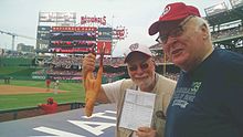 "Rubber Chicken Man" Hugh Kaufman compares notes on the Washington Nationals with baseball writer Paul Dickson. Rubber Chicken Man with baseball writer Paul Dickson.jpg