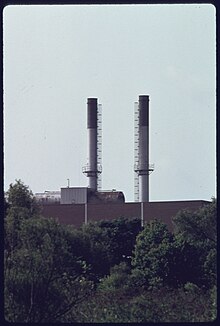 Same smokestacks in 1975 after the plant was closed in a push for greater environmental protection SMOKESTACKS OF THE HOLMES ROAD INCINERATOR, NO LONGER POLLUTE THE ATMOSPHERE. THE PLANT PREVIOUSLY BURNED OLD... - NARA - 557411.jpg