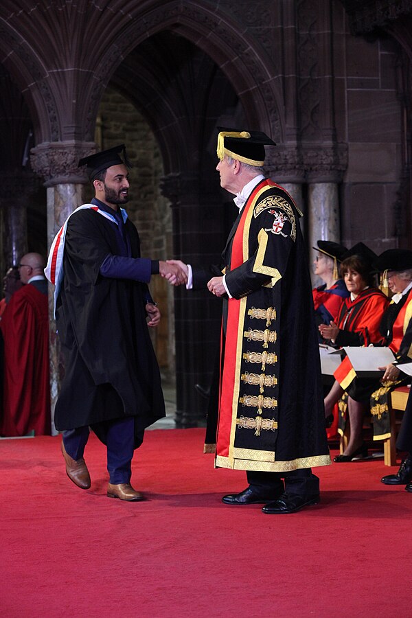 Brandreth awarding a degree to a student at a 2017 graduation ceremony of the University of Chester in Chester Cathedral