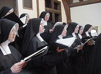 Sisters of the Daughters of Mary in traditional habit. Sisters (Daughters of Mary) Roman Catholic Singing.jpg