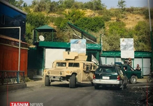 Taliban Humvee and technical drive past defaced Ahmad Shah Massoud placards after the fall of Panjshir Valley. Taliban in front of defaced Ahmad Shah Massoud placards.png