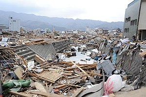 US Navy 110315-N-2653B-144 Vehicles and debris line a canal in the downtown area of Ofunato, Japan.jpg