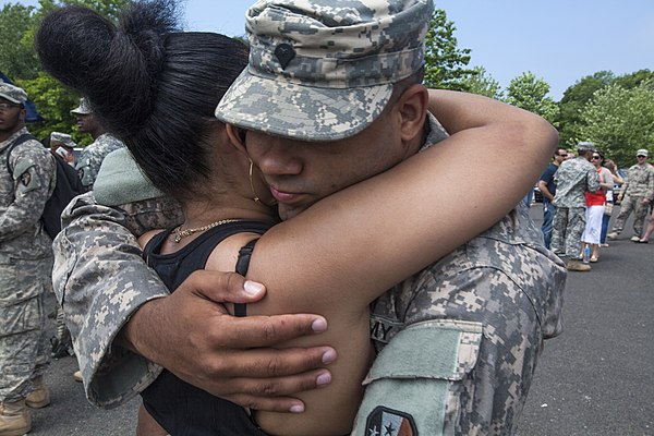 A soldier of the 1-114th Infantry reunites with his family at the Joint Training and Training Development Center, Fort Dix (Joint Base McGuire-Dix-Lak