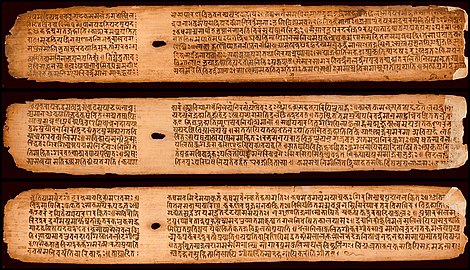 A few palm leaves from the Buddhist Sanskrit text Shisyalekha composed in the 5th century by Candragomin. Shisyalekha was written in Devanāgarī script by a Nepalese scribe in 1084 CE. The manuscript is in the Cambridge University library.[41]