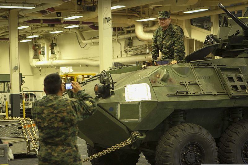File:A Peruvian marine poses for a photo in a light armored vehicle during a tour of the amphibious assault ship USS America (LHA 6) in Peru Sept 140901-M-HB658-116.jpg
