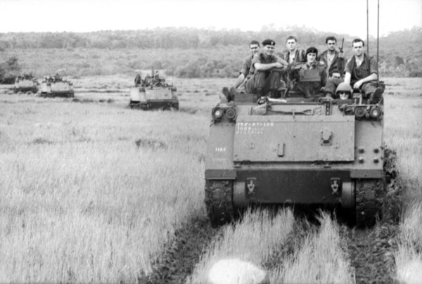 M113s from the 1st Armoured Personnel Carrier Squadron carrying soldiers of the 6th Battalion, Royal Australian Regiment during the Vietnam War