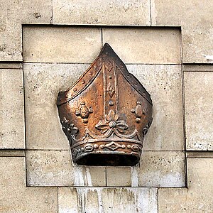 Photograph of a bishop's mitre set in a wall.
