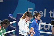 Deutsch: Boxen bei den Olympischen Jugendspielen 2018 Tag 12, 18. Oktober 2018 - Medaillenzeremonie im Fliegengewicht der Mädchen - Gold: Martina La Piana (Italien), Silber: Adijat Gbadamosi (Nigeria), Bronze: Heaven Destiny Garcia (USA); Medaillenübergabe durch Habu Gumel (IOC, Nigeria), Geschenkübergabe durch Dr. Joseph O. Ayeni (Nigeria, AIBA). English: Boxing at the 2018 Summer Youth Olympics on 18 October 2018 – Girl's flyweight Medal Ceremony - Gold: Martina La Piana (Italy), Silver: Adijat Gbadamosi (Nigeria), Bronze: Heaven Destiny Garcia (USA); Medal handover by Habu Gumel (IOC, Nigeria), Gift presented by Dr. Joseph O. Ayeni (Nigeria, AIBA). Español: Boxeo en los Juegos Olímpicos Juveniles de Verano de 2018 en 18 de octubre de 2018 - Ceremonia de la Medalla de peso mosca para niñas - Oro: Martina La Piana (Italia), Plata: Adijat Gbadamosi (Nigeria), Bronce: Heaven Destiny Garcia (Estados Unidos); Entrega de medallas por Habu Gumel (COI, Nigeria), Regalo presentado por Joseph O. Ayeni (Nigeria, AIBA).