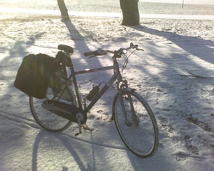 A bicycle set up for winter commuting with metal-studded tires, an enclosed chain case, and enclosed drum brakes.