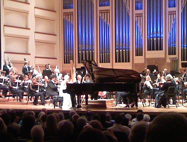 Performance of a piano concerto involves a piano on stage with the orchestra