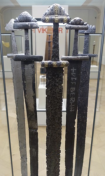 File:Cultural History (historisk) Museum Oslo. VIKINGR Norwegian Viking-Age Exhibition 11 Elaborate swords, decorated hilts, ornated blades, home-forged and foreign-made, ca 800-1000. Found in Telemark, Nordland, Hedmark. 4707.jpg