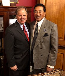 Robinson with Senator Doug Jones while testifying at the United States Congress to support the CLASSICS Act in 2018 Doug Jones and Smokey Robinson.jpg