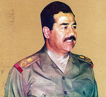 President Saddam Hussein of Iraq wearing an olive green ascot as a part of his Iraqi Army field marshal's uniform.