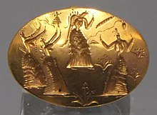 A much-discussed gold signet ring from Knossos, perhaps showing a goddess and worshippers Gold signet ring from Cnossos drawing on the epiphany cycle, Archaeological Museum of Heraklion (cropped).jpg