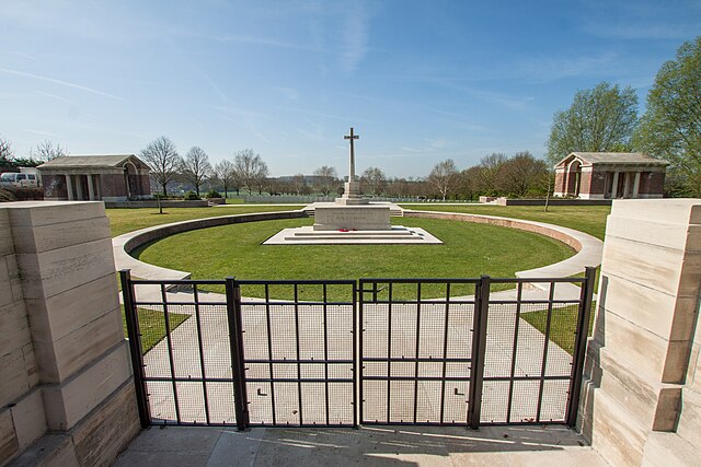 Hooge Crater Cemetery entrance with Cross of Sacrifice and the stone-faced circle designed by Sir Edwin Lutyens in memory of the many craters nearby