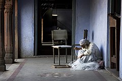 Old handy man repairing a rope chair in Delhi India