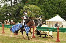 Knights jousting, pieces of broken lance tips flying.jpg