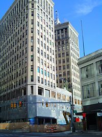 Demolition barricades around street level in autumn 2009. LafayetteBldgDetroitdemobegins.JPG