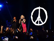 Madonna and her son, David Banda on stage in Paris, in December 2015. She paid tribute to victims and survivors of the November 2015 Paris attacks Madonna - Rebel Heart Tour 2015 - Paris 2 (23491182804).jpg