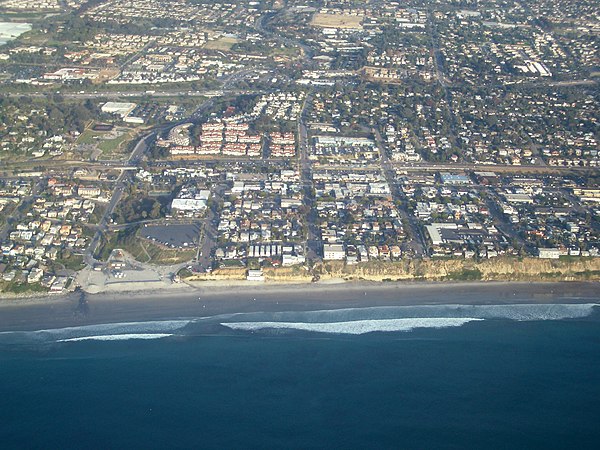 Aerial view of part of old town Encinitas showing Moonlight Beach on the left. Parallel with the shore is Historic Coast Highway 101; also parallel an