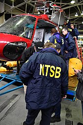 NTSB investigators examine the recovered wreckage of N350LH on March 13, 2018 NTSB DSC 0243 (39163518050).jpg