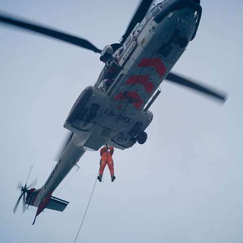 A second (previously lowered) second swimmer diver is returned to the helicopter)