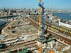 View over earthworks and construction-sites, Oosterdijkseiland; cityscape over Amsterdam, April 2005; free photo, Fons Heijnsbroek