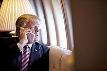 President Trump making a phone call in 2017. He used pseudonyms during call-in interviews throughout the 1980s and 1990s. President Trump's First 100 Days- 6 (34252546901).jpg