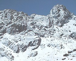 The mountain named Wamp'una; entrance to Qaqa Mach'ay at left centre Qaqa Mach'ay Peru.jpg